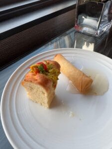 One tiny sandwich and a spring roll.